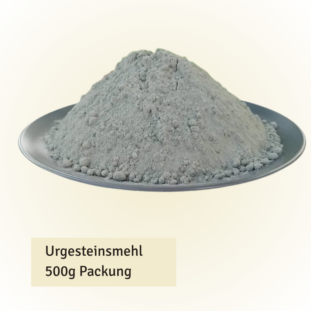 Pile of gray rock flour powder heaped on a silver plate, labeled 'Urgesteinsmehl 500g Packung'